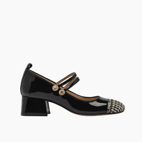 Black patent leather shoe with a decorative strap and heel 