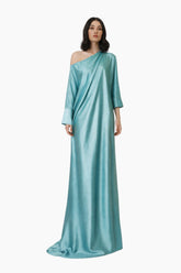 Woman wearing a light blue one-shoulder gown on a white background