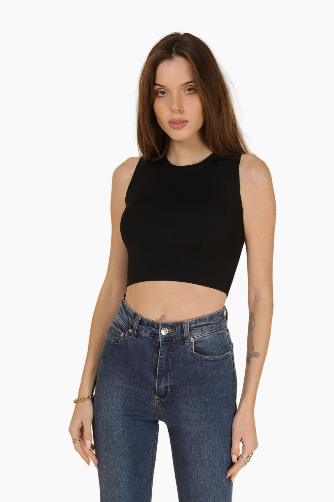 Woman wearing a black sleeveless top and blue jeans 