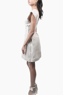 Woman wearing a white dress with lace-up front 