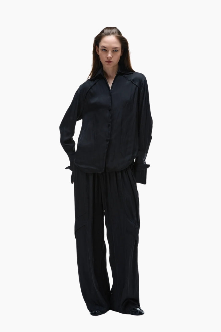 Person wearing a Silky Layers Trouser and black long sleeve shirt