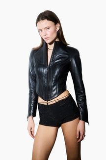 Woman wearing a black leather jacket with a black glittery short