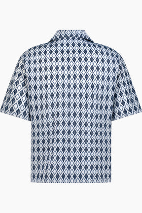 Short-sleeve shirt with a blue and white geometric pattern.