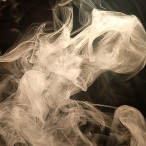 White smoke or ink swirling against a dark background