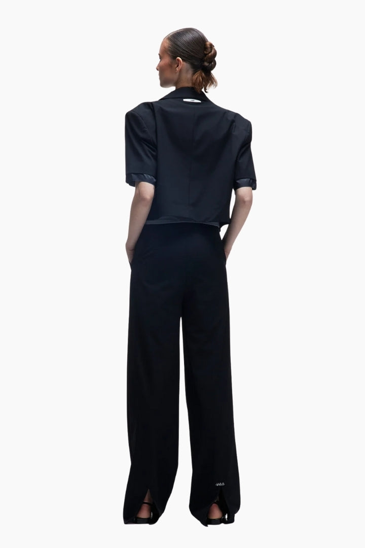 Person wearing a black outfit with wide-leg pants