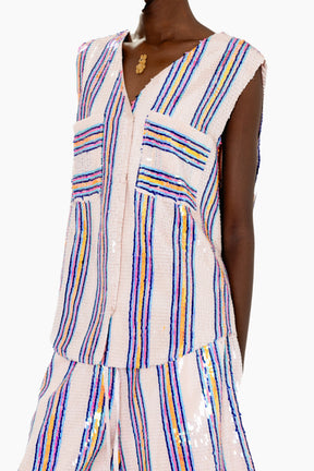 Woman wearing a Eye-catching vest featuring a sleeveless V-neck vest adorned with pastel and metallic vertical stripes for a shimmering finish.