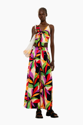 Model wearing a Flowing wide-leg pants with a striking oversized leaf motif in vivid hues.
