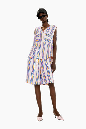 Woman wearing a striped outfit with a sleeveless top and skirt 