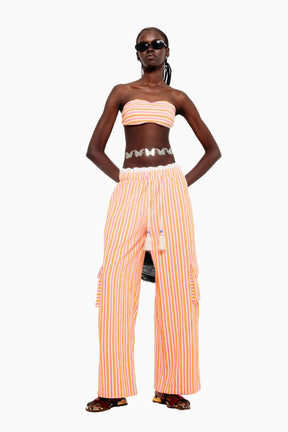 Model wearing a crop top with Wide-leg terry pants with multicolor stripes, elastic waist, tassel ties, and cargo-style side pockets.