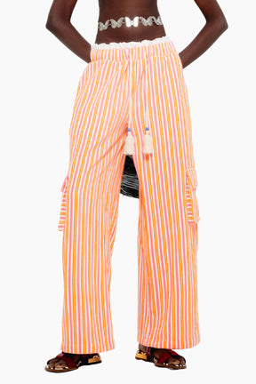 Model wearing a crop top with Wide-leg terry pants with multicolor stripes, elastic waist, tassel ties, and cargo-style side pockets.