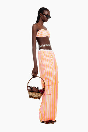 Model wearing a crop top with Wide-leg terry pants with multicolor stripes, elastic waist, tassel ties, and cargo-style side pockets.