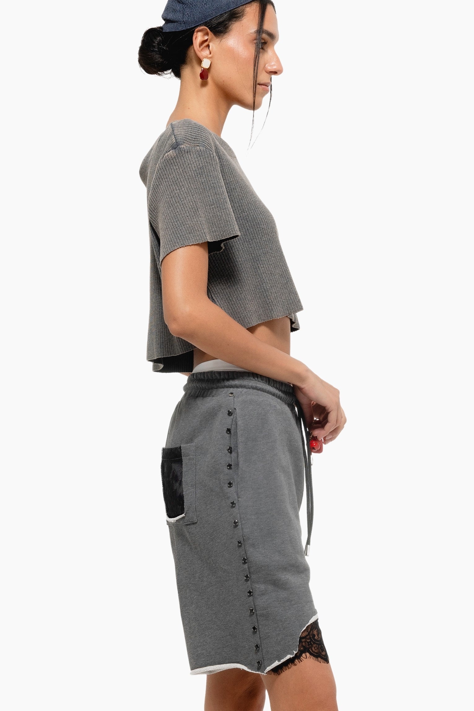 Woman wearing a gray outfit with a cap 