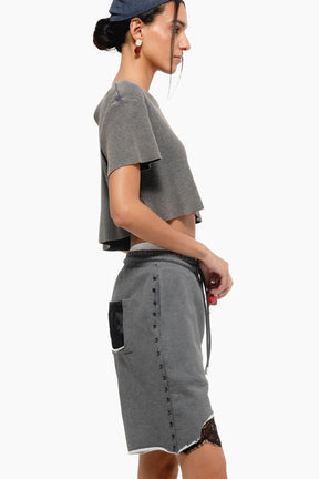 Woman wearing a gray outfit with a cap 