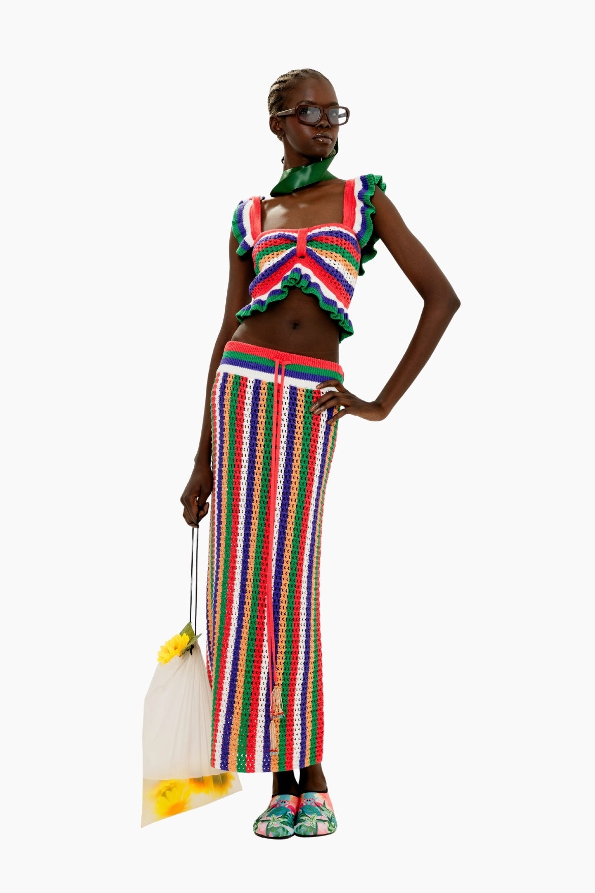 Woman wearing a colorful outfit Colorful striped crochet skirt with a fitted silhouette and tassel detail and top 