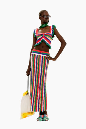 Woman wearing a colorful outfit Colorful striped crochet skirt with a fitted silhouette and tassel detail and top 
