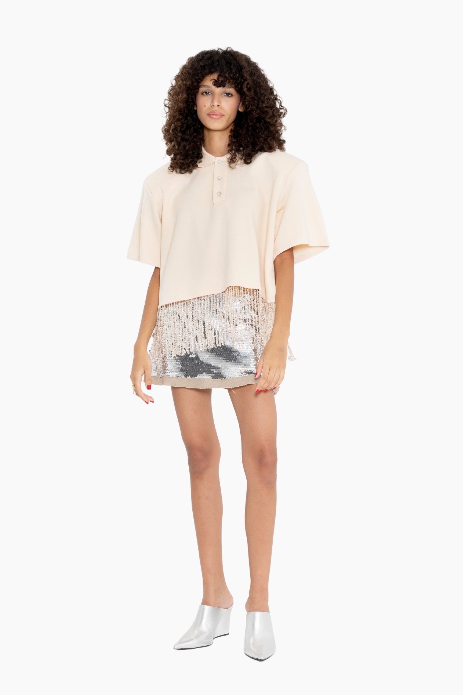 Woman wearing a beige top and patterned skirt 