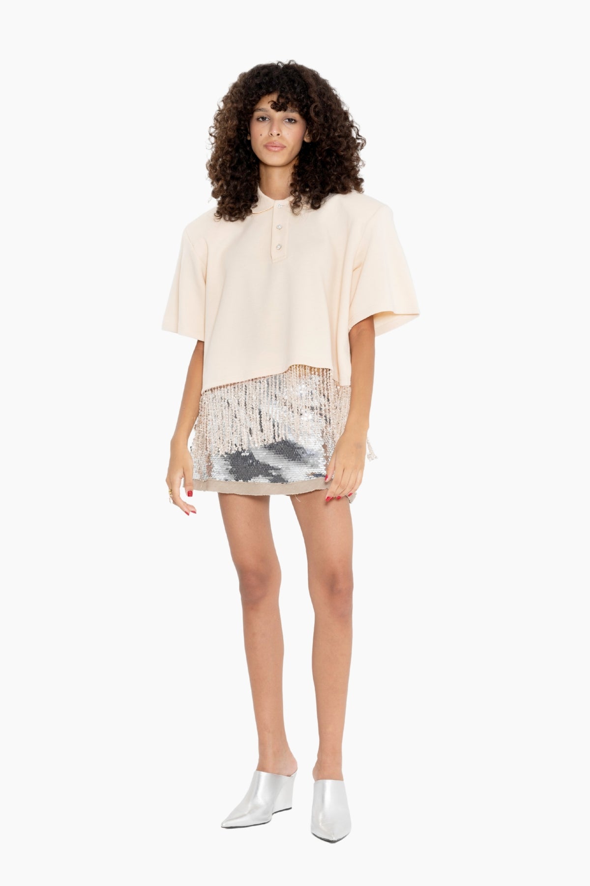 Woman wearing a beige top and patterned skirt 