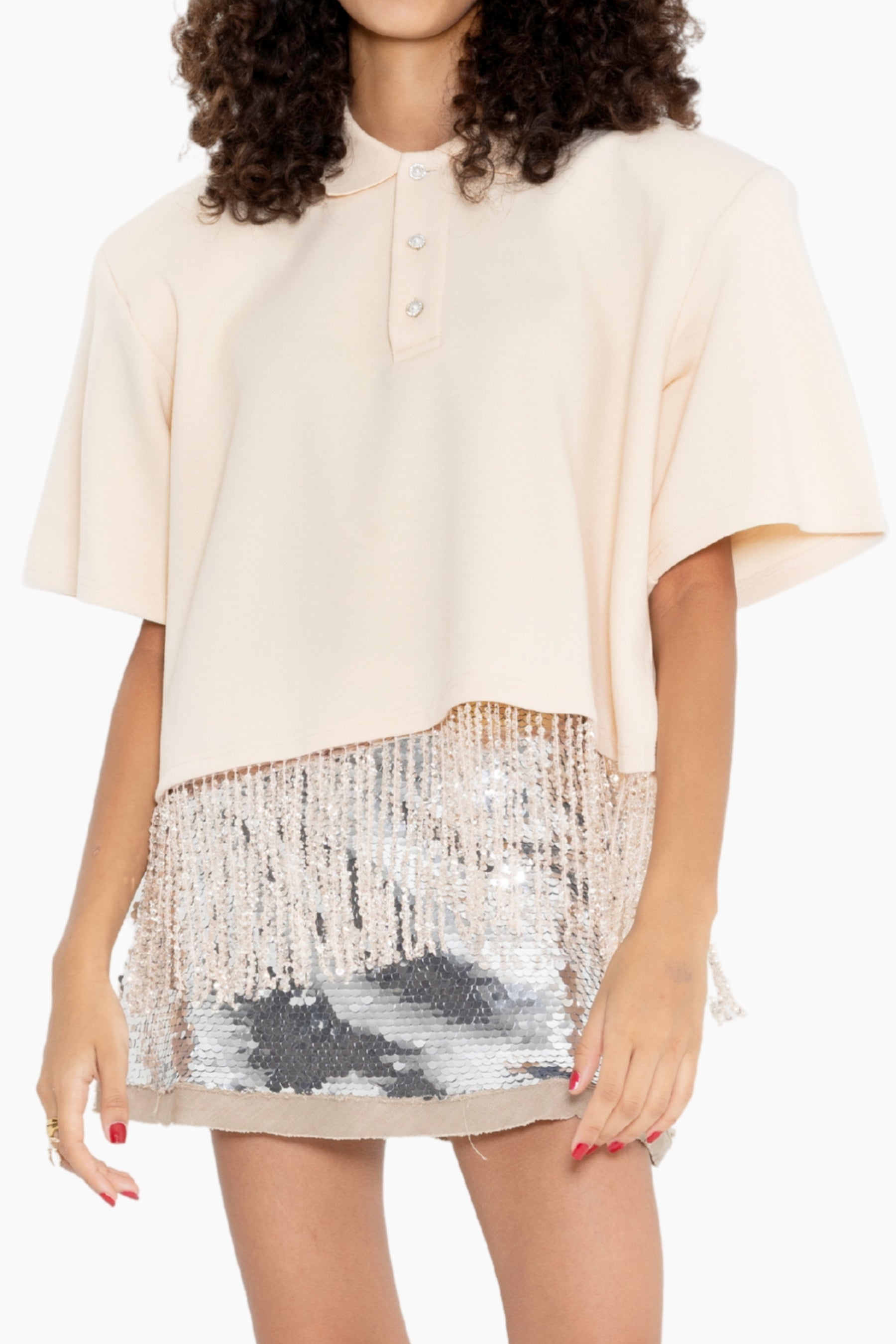 Woman wearing a beige blouse and sequin skirt