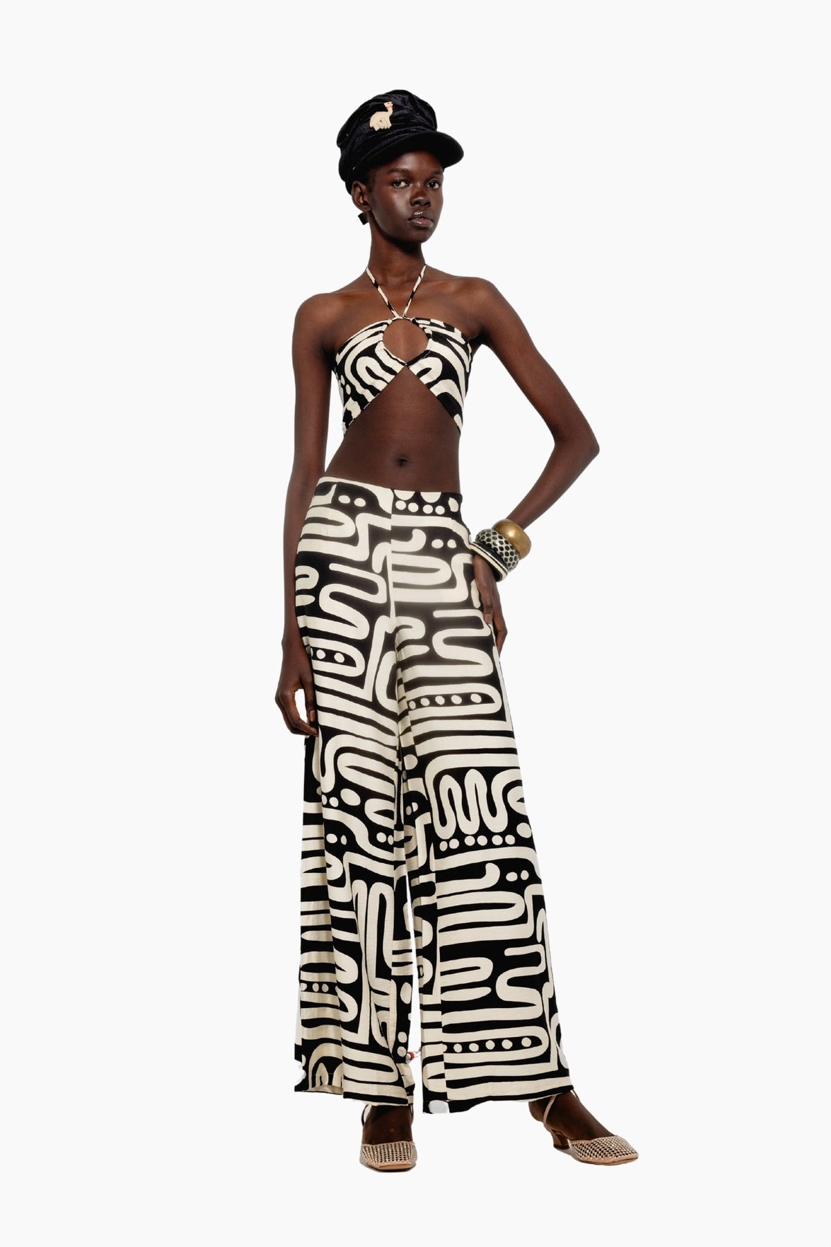 Model wearing a crop top features a bold black-and-white abstract print with a halter neck and a matching pants 