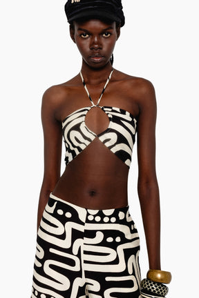 Woman wearing a black and white patterned outfit