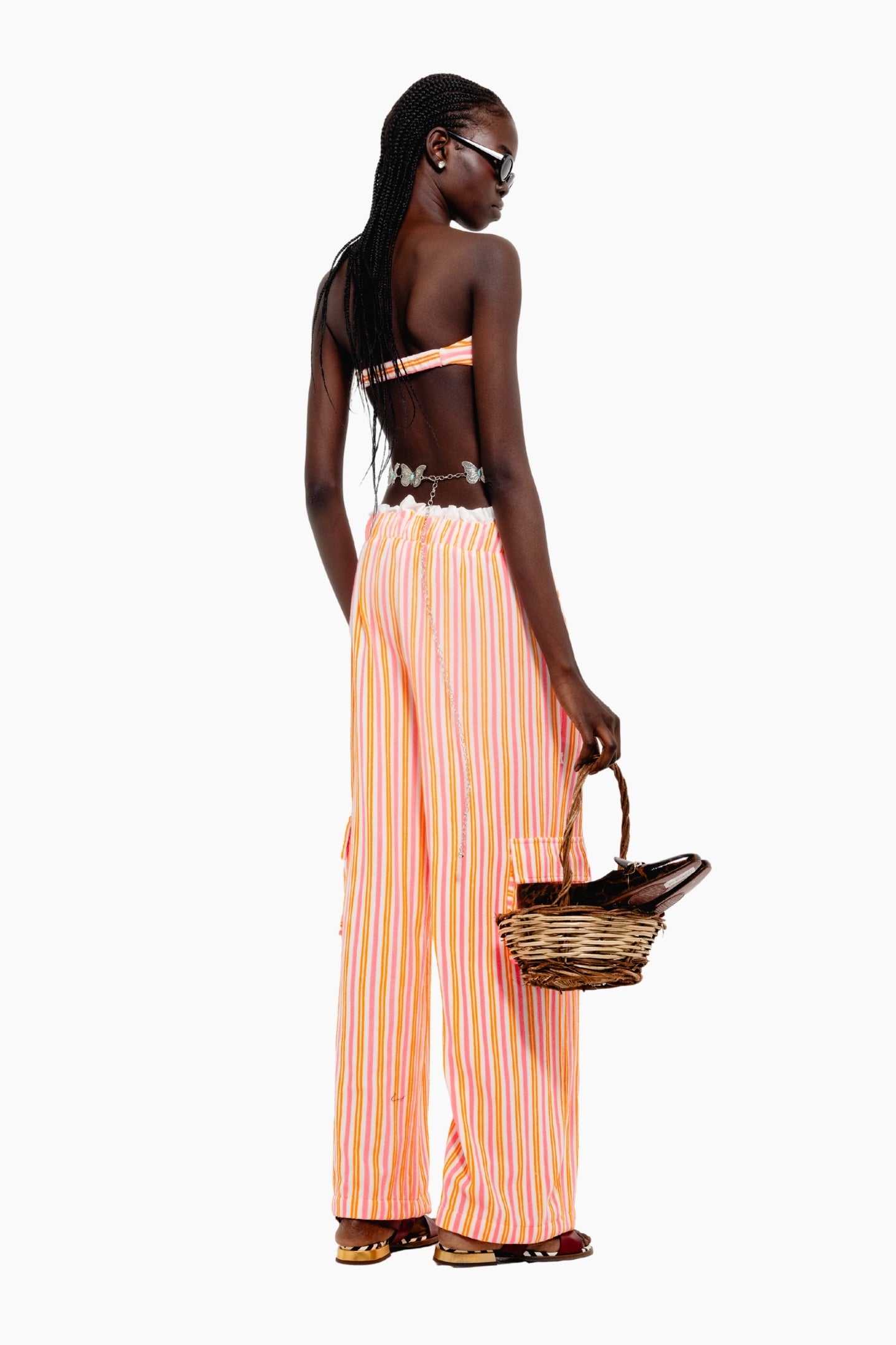 Woman wearing a colorful striped outfit, top and matching pants