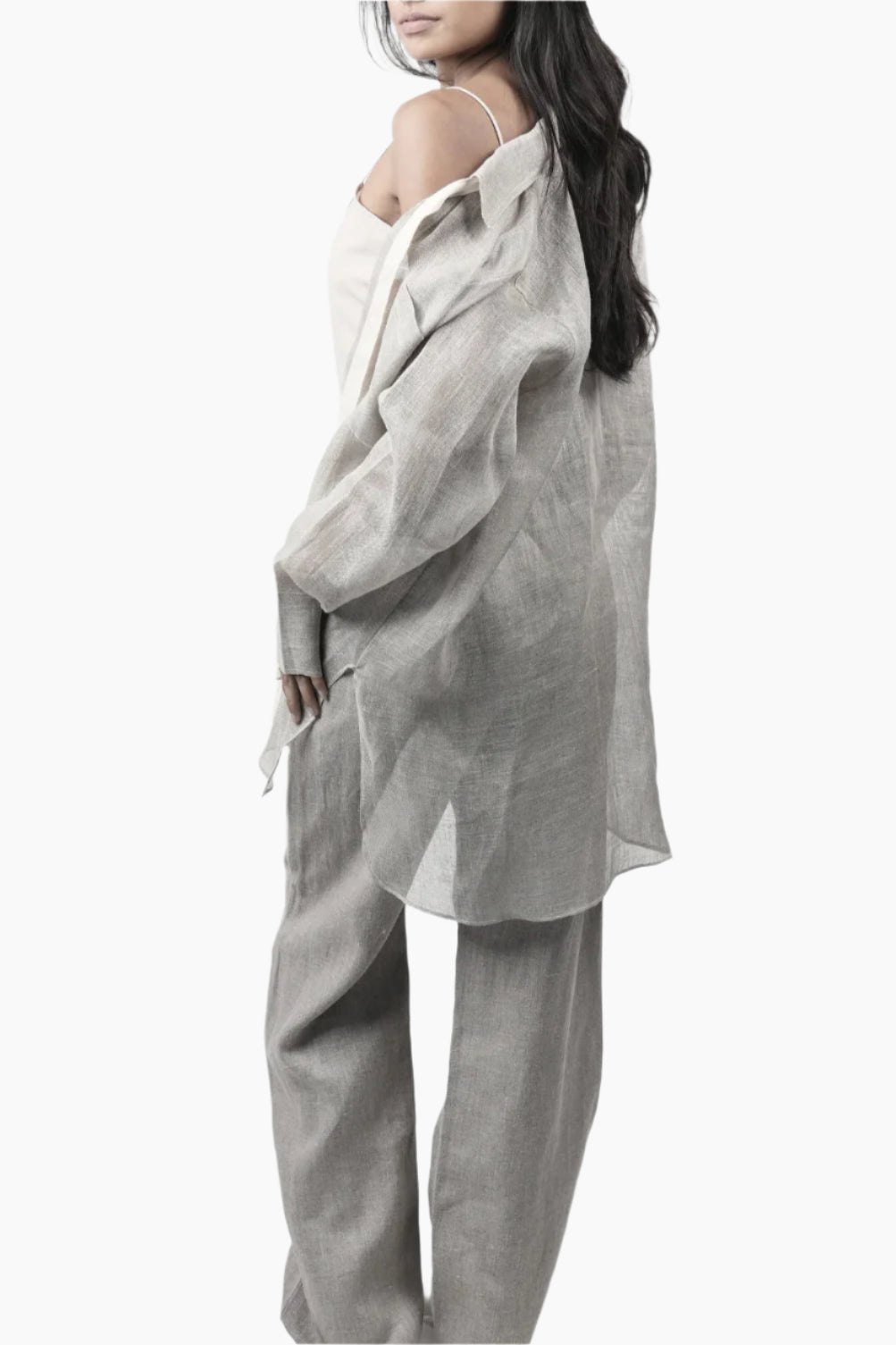A sheer linen collar shirt with crystal adorned from pockets and a cotton ribbon necktie, perfectly paired with straight linen pants.