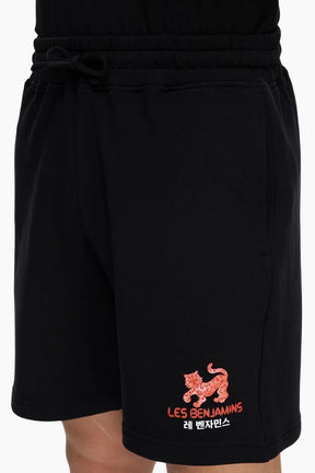 Black shorts with a red tiger logo and text 