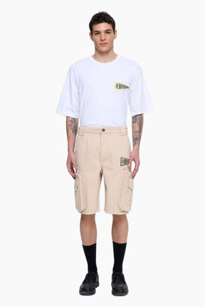 Person wearing a white t-shirt and beige cargo shorts 