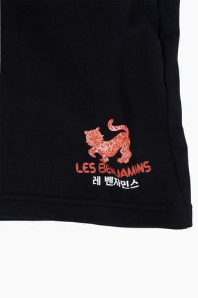 Black garment with red embroidered logo and text 