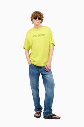 Person wearing a bright yellow t-shirt and blue jeans