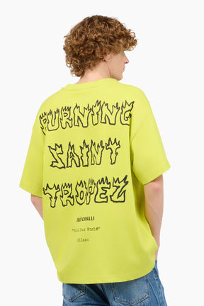 Person wearing a bright yellow t-shirt with text on the back