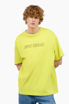 Person wearing a bright yellow t-shirt with text