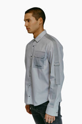 Model wearing a light blue shirt with a side pocket