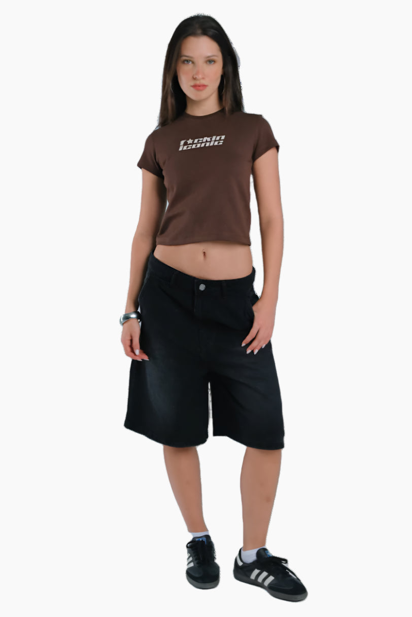 Woman wearing a brown t-shirt with 'Iconic' text 