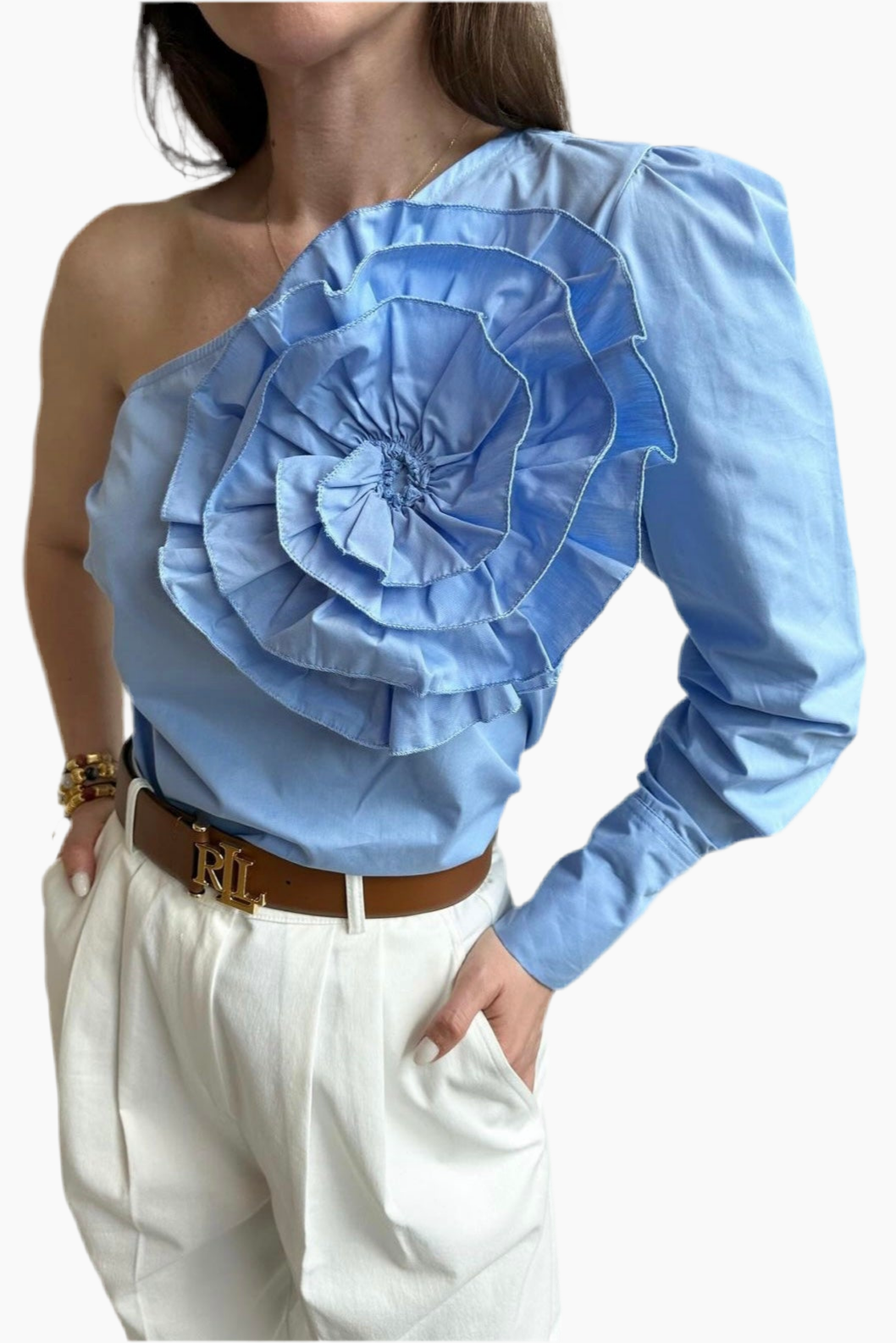 Light blue one-shoulder top with large floral design worn by a person on a white background