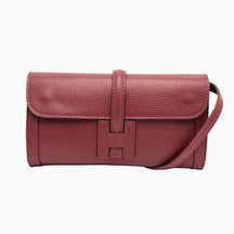 Red leather handbag with a strap on 