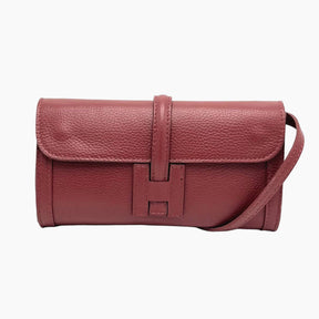 Red leather handbag with a strap on 