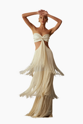 Woman wearing a flowing beige dress 