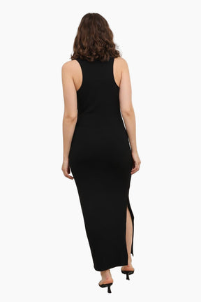 Woman wearing a black sleeveless dress with a slit 