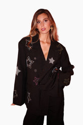 Woman wearing a black outfit with star designs 