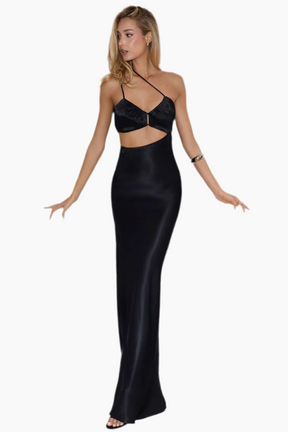 Woman wearing a black dress with cut-out design.