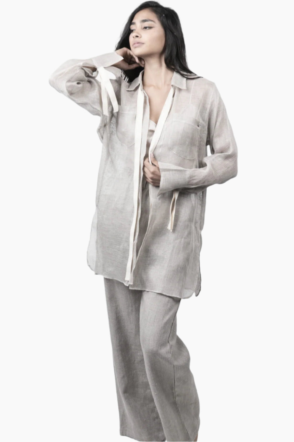 Woman wearing a light gray suit with a white shirt 