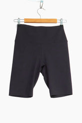 Black shorts hanging on a wooden hanger