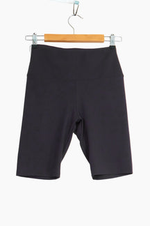 Black shorts hanging on a wooden hanger