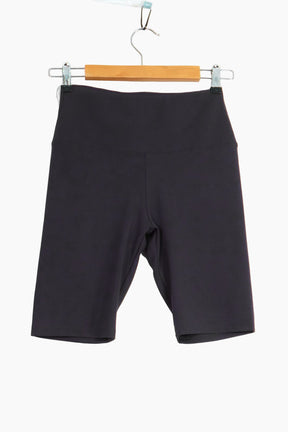 Black shorts hanging on a wooden hanger