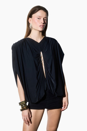 Draped mini dress. Featuring statement shoulders and a bold front cut-out detail. Designed with a bodycon draped mini skirt to highlight a feminine silhouette.