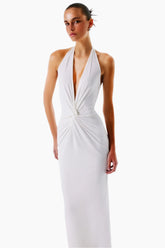 Woman wearing a white halter neck dress 