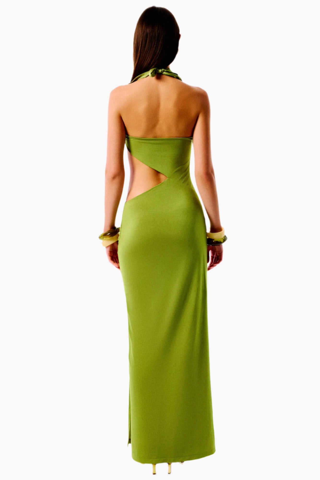 Woman wearing a green evening gown with cut-out design 