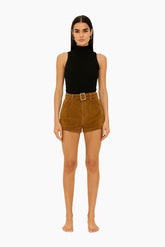 Woman wearing a black sleeveless top and brown shorts 