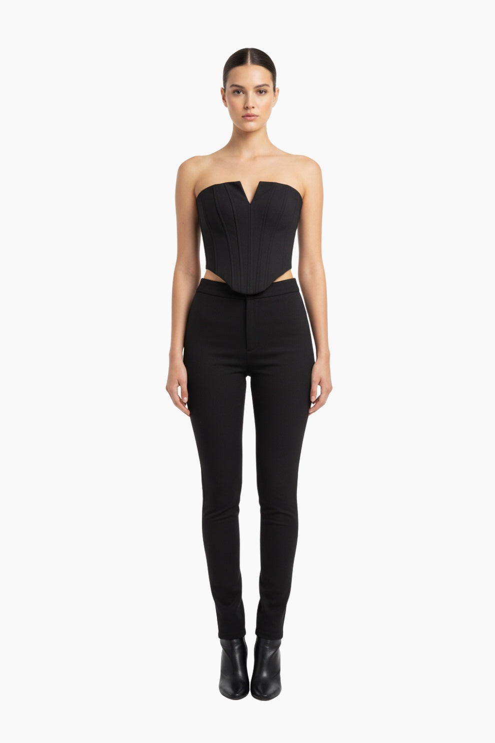 Woman wearing a black strapless top and high-waisted black pants 